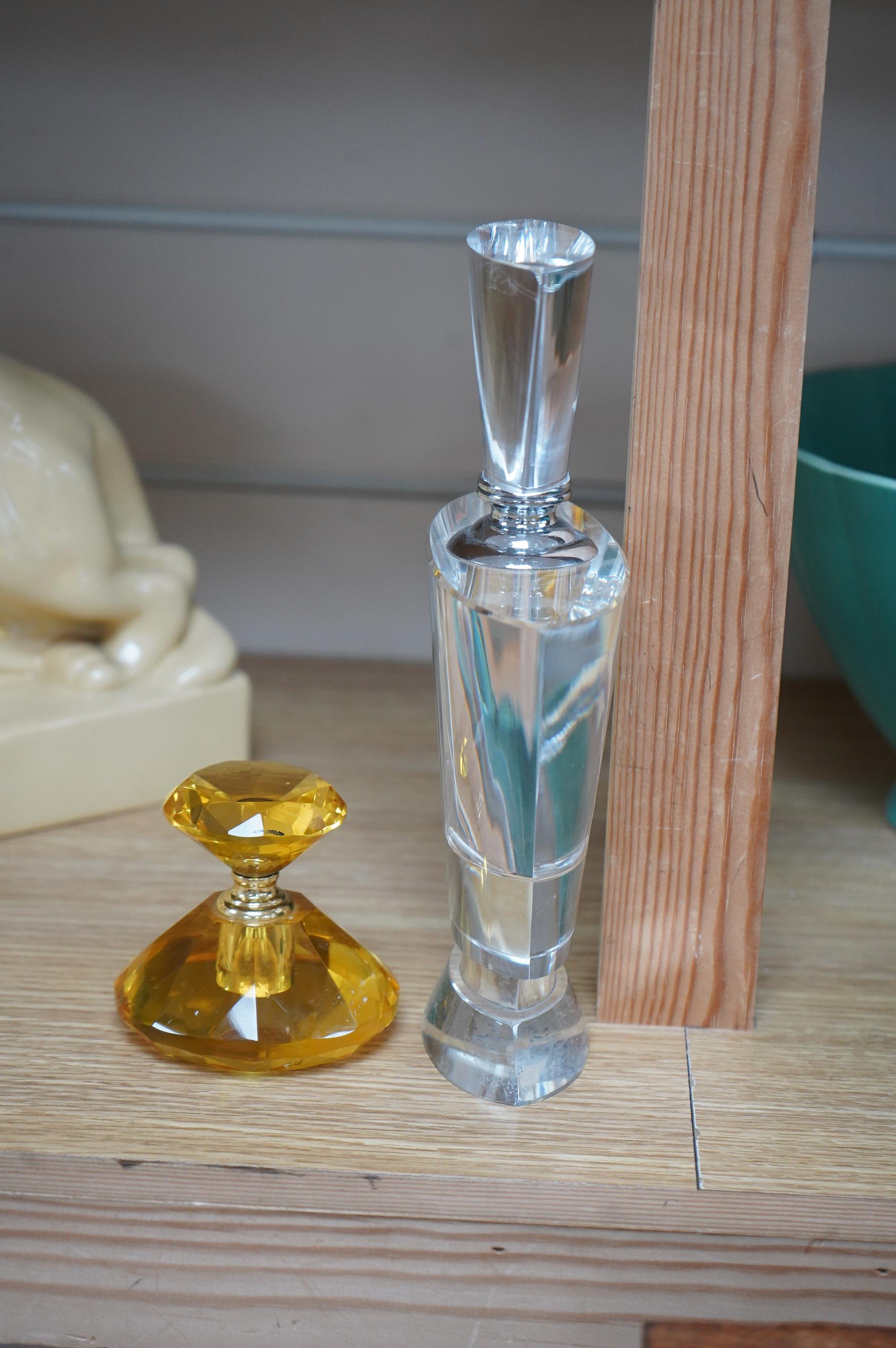 An amber glass perfume bottle and an oversized Art Deco style glass perfume bottle
